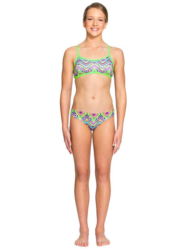 Standing model in colorful geometric bikini, white background
