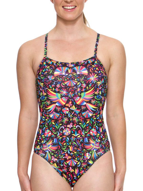 Smiling woman in colorful patterned one-piece swimsuit