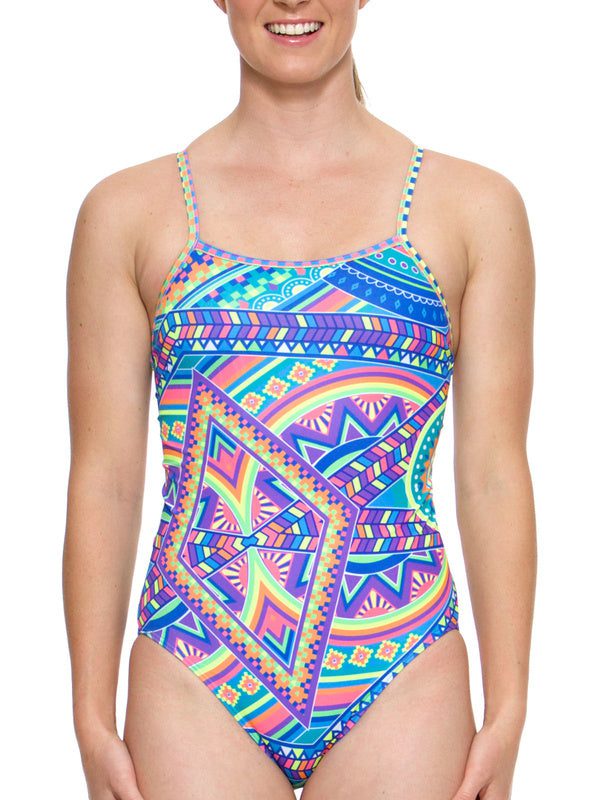 Woman wearing colorful geometric patterned one-piece swimsuit