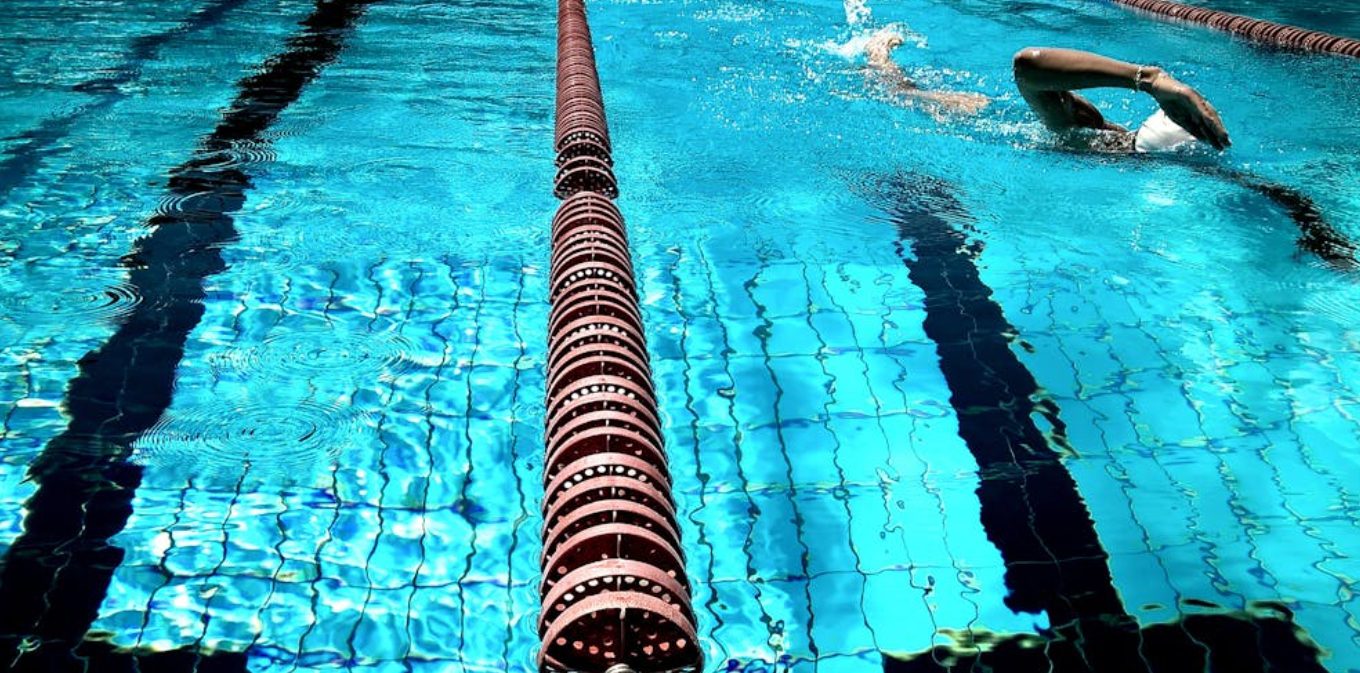 Swimmer doing freestyle in pool lane